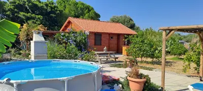 a garden with a hot tub in front of a house at Villa Soroni in Soroni