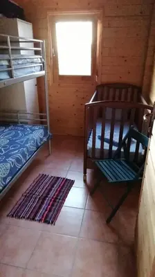 a room with two bunk beds and a window at Villa Soroni in Soroni