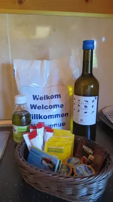 a basket of food and a bottle of wine on a counter at Villa Soroni in Soroni