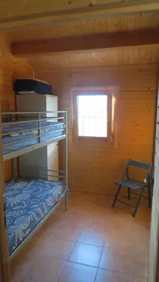 a room with two bunk beds and a window at Villa Soroni in Soroni