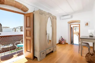 a room with a large wooden cabinet and a table at Villa Lindia in Líndos