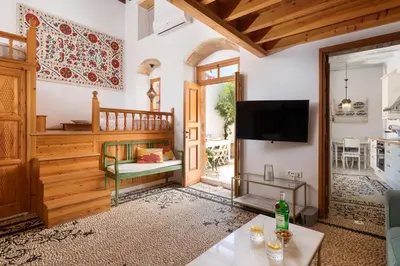 a living room with a television and a table at Villa Lindia in Líndos