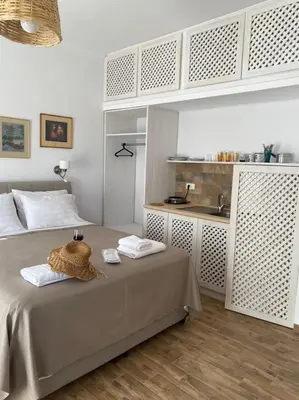 a bedroom with a bed with a sink in it at Reginas Apartments in Ixia