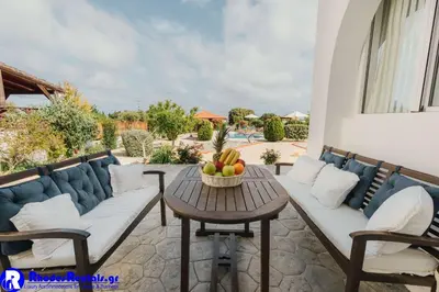 a patio with a couch and a table with fruit on it at Gennadi Dreams Holiday Villa in Gennadi
