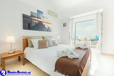 a bedroom with a bed with a view of the ocean at Gennadi Dreams Holiday Villa in Gennadi