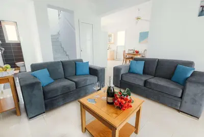 a living room with two couches and a table at Gennadi Dreams Holiday Villa in Gennadi