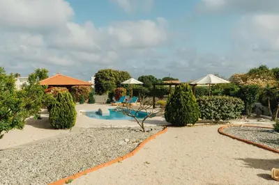 a resort with a swimming pool and umbrellas at Gennadi Dreams Holiday Villa in Gennadi