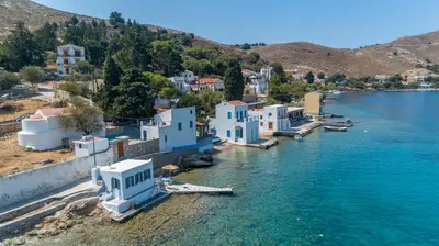 an aerial view of a village on the water at On The Rocks in Symi