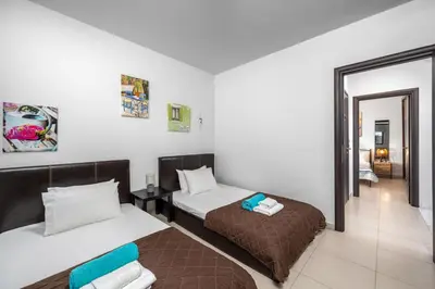 a small room with two beds and a hallway at Articiano Villa in Faliraki