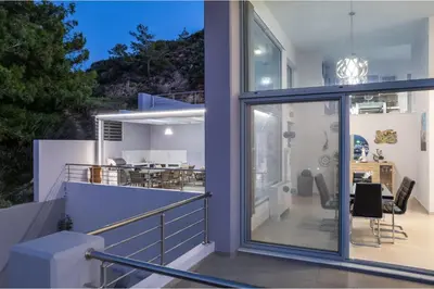 a house with sliding glass doors on the balcony at Articiano Villa in Faliraki
