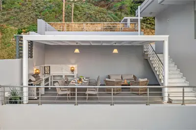 a balcony with a table and chairs on a house at Articiano Villa in Faliraki