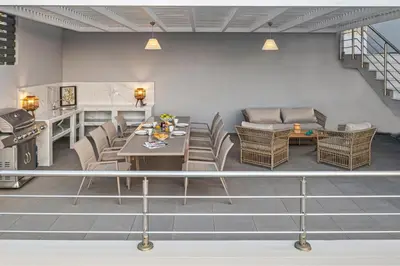 a living room with a table and chairs at Articiano Villa in Faliraki