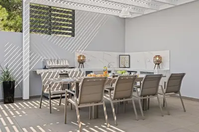 a kitchen and dining room with a table and chairs at Articiano Villa in Faliraki