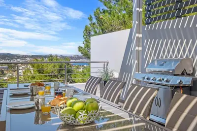 a table with a bowl of fruit on a balcony at Articiano Villa in Faliraki