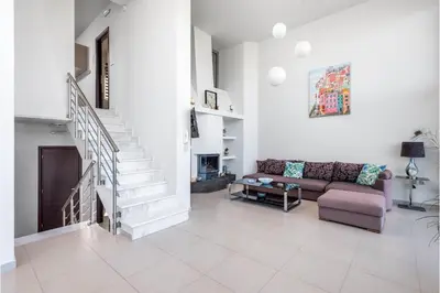 a living room with a couch and a staircase at Articiano Villa in Faliraki
