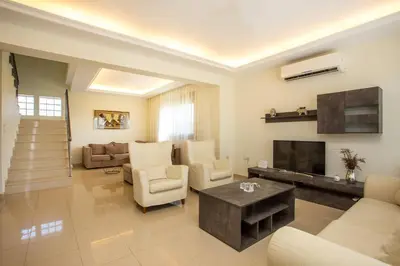 a living room with a couch and a fireplace at Muses villa in Pastida