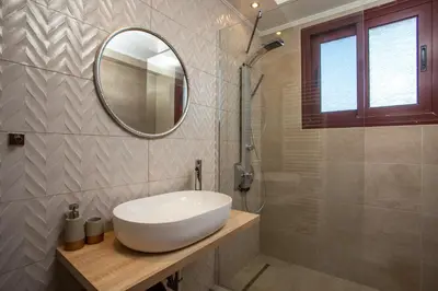 a bathroom with a white sink and a mirror at Muses villa in Pastida