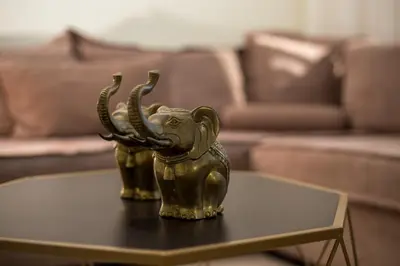 a gold elephant statue sitting on a table in a living room at Muses villa in Pastida