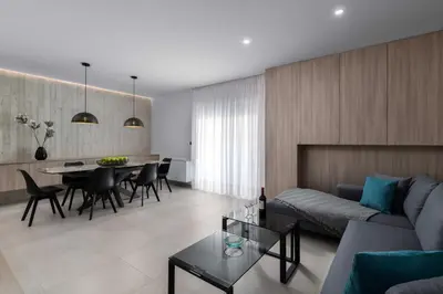 a living room with a couch and a table at Kallia Sea Breeze - 3 Bedroom Apartment in Rhodes Town