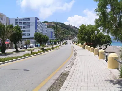 an empty street with trees and buildings on a beach at Kallia Sea Breeze - 3 Bedroom Apartment in Rhodes Town