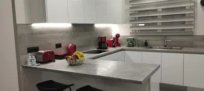 a kitchen with a bowl of fruit on a counter at Kallia Sea Breeze - 3 Bedroom Apartment in Rhodes Town