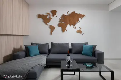 a living room with a couch and a world map on the wall at Kallia Sea Breeze - 3 Bedroom Apartment in Rhodes Town