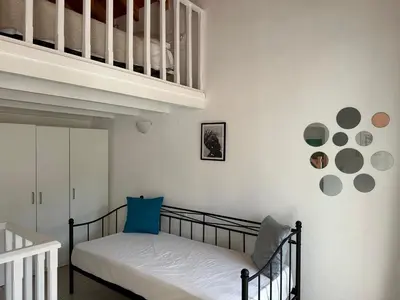 a bedroom with a crib and a stair case at Casa Di Rosse in Symi