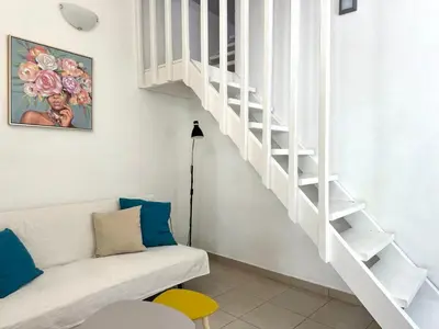 a white staircase in a living room with a couch at Casa Di Rosse in Symi