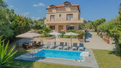 a villa with a swimming pool and a house at Emma's Luxury Villa in Pastida