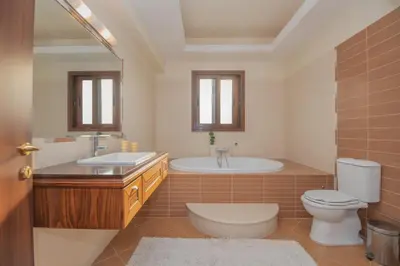 a bathroom with a tub and a toilet and a sink at Emma's Luxury Villa in Pastida