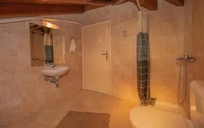 a bathroom with a shower and a toilet and a sink at Emma's Luxury Villa in Pastida