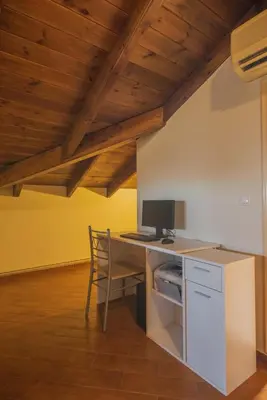 a kitchen with a desk with a computer on it at Emma's Luxury Villa in Pastida