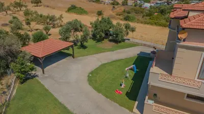 an aerial view of a backyard with a playground at Emma's Luxury Villa in Pastida