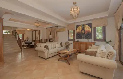 a living room with couches and a table at Emma's Luxury Villa in Pastida