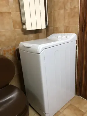 a white toilet in a bathroom with a counter at Lemon tree's house in Kalavárda