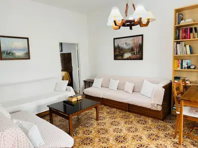 a living room with two couches and a table at Lemon tree's house in Kalavárda