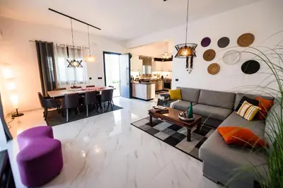 a living room with a couch and a table at El Sueno Villa in Gennadi