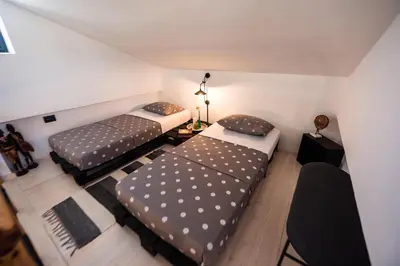 a room with two beds and a table at El Sueno Villa in Gennadi