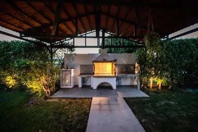 a white table in a garden at night at El Sueno Villa in Gennadi