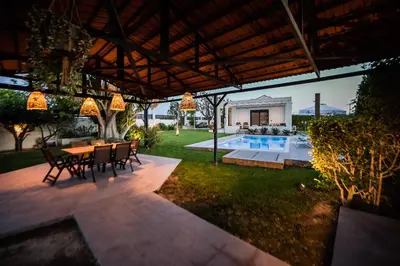 a patio with a table and chairs and a pool at El Sueno Villa in Gennadi