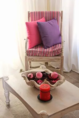 a coffee table with a couch and flowers on it at Muse Neate in Halki