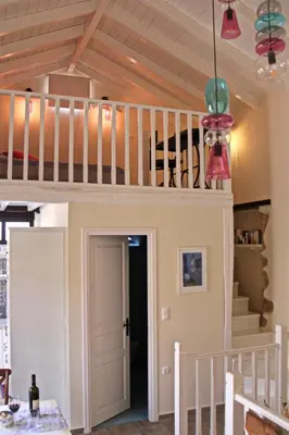 a loft bed in a room with a staircase at Muse Neate in Halki