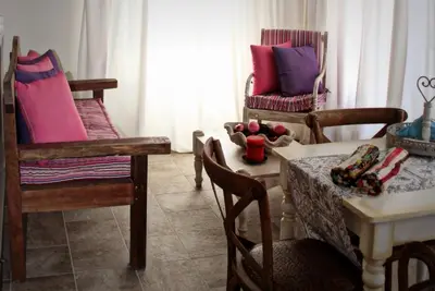 a living room with chairs and a table and a tableablish at Muse Neate in Halki
