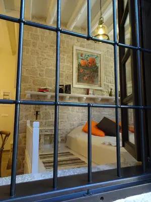 a view of a bedroom through a window at Muse Mese in Halki