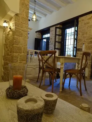 a kitchen with a table with a candle and chairs at Muse Mese in Halki