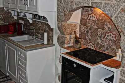 a small kitchen with a sink and a stove at Muse Mese in Halki