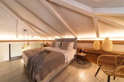a bedroom with a bed and a table and chairs at Anastasia Grand Villa in Kattavía