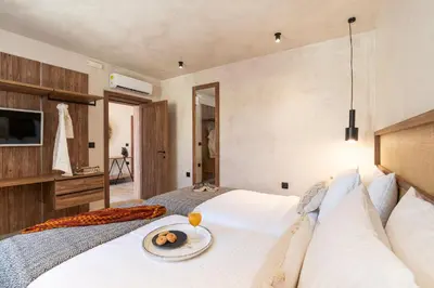 a bedroom with a bed with a plate of fruit on it at Anastasia Grand Villa in Kattavía