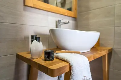 a bathroom with a white sink on a wooden table at Anastasia Grand Villa in Kattavía