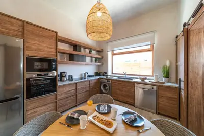 a kitchen with a table and chairs and a dining room at Anastasia Grand Villa in Kattavía